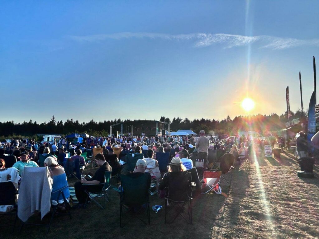 The sun setting over the crowd in front of the stage at Derwent Fest