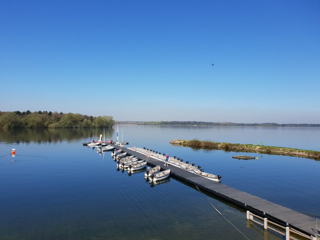 The pier at Hanningfield Waterside Park. Speedboats are docked on both sides