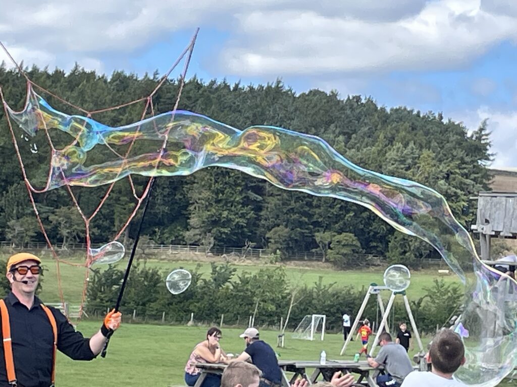 Bubbleologist with a giant bubble in the outdoors
