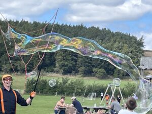 Bubbleologist making giant bubbles outdoors
