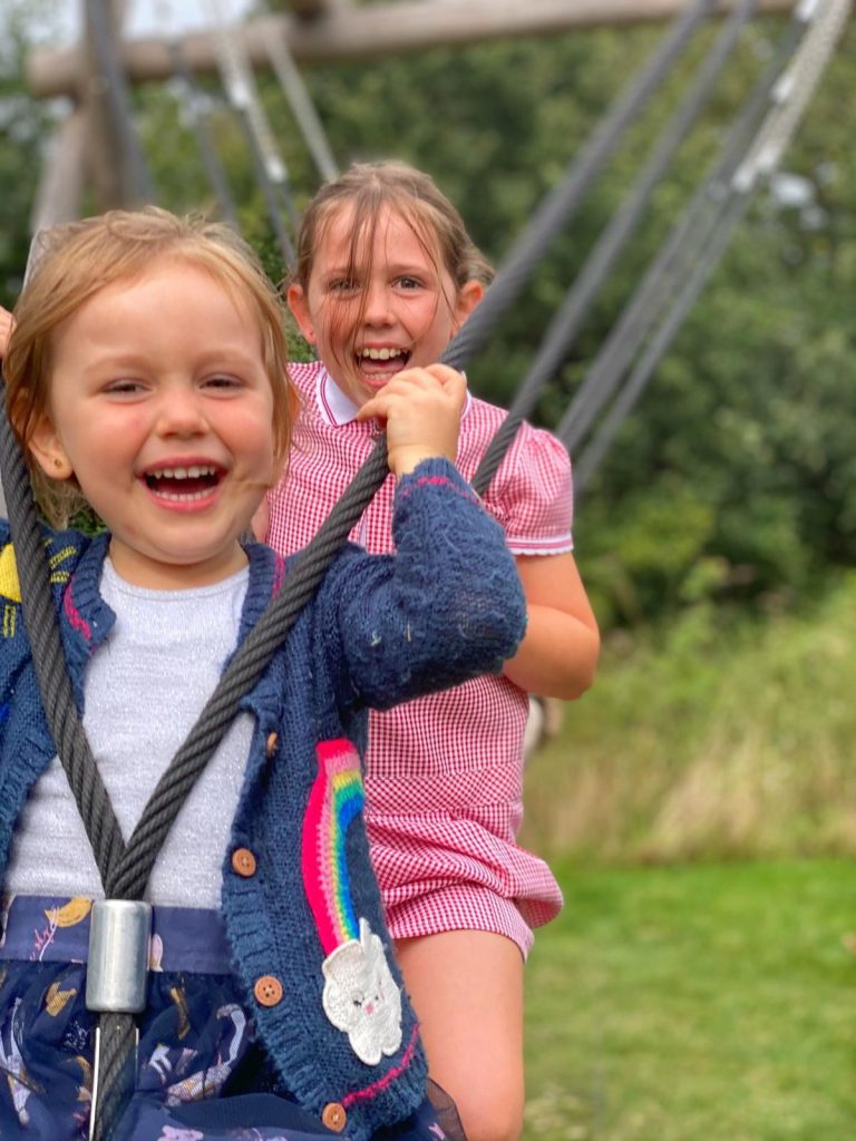 Two young girls playing on the Viper Swing at Hanningfield Waterside Park